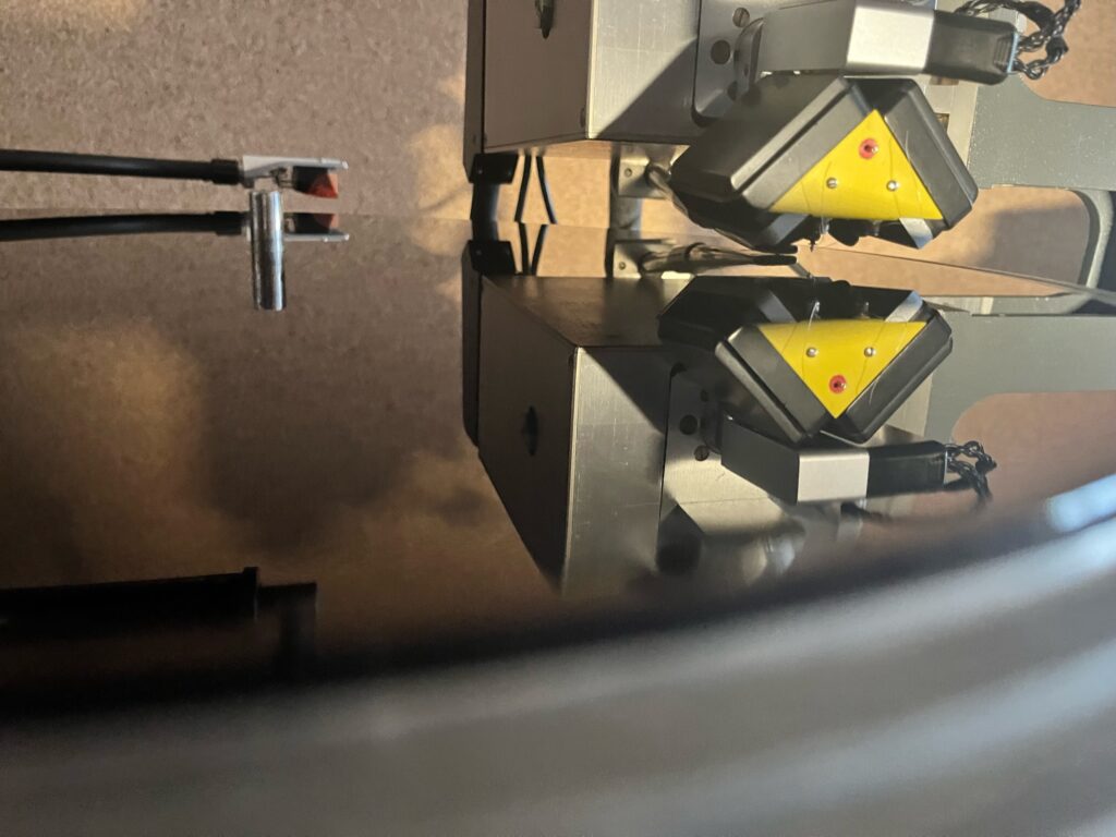 The lathe’s cutterhead and tone arm, reflected in the surface of a lacquer